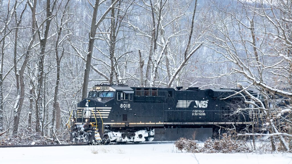 A Norfolk Southern locomotive travels along the Susquehanna River during light snowfall in this file photo from February. The region will see another major snow storm this weekend. PAUL WEAVER/SOPA Images/LightRocket VIA GETTY IMAGES