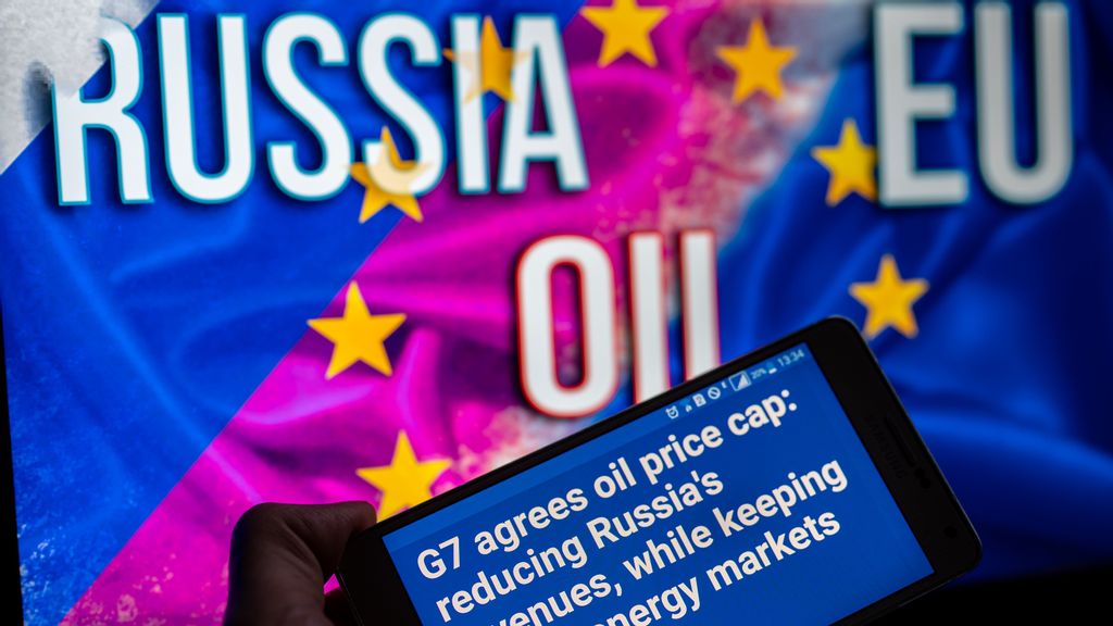 EU logo with Russian flag on screen with EU Commission press release on mobile. EU Russian oil Price cap, EU agrees $60 price cap on Russian oil. In Brussels, Belgium on 4 December 2022. The European Union relied on Russia for its natural gas, which now they're looking to rely on less. NURPHOTO/BENZINGA