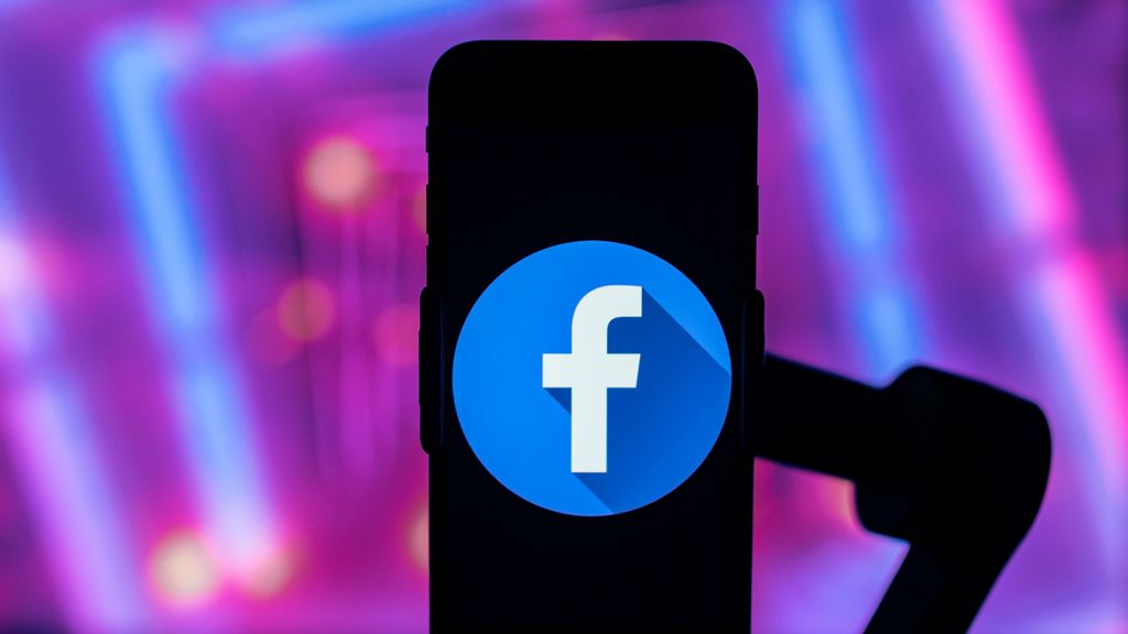 In this photo illustration, a Facebook logo is seen displayed on a mobile phone screen. Then-Facebook banned former president Donald Trump from the platform after inciting violence on January 6. SOPA IMAGES/BENZINGA