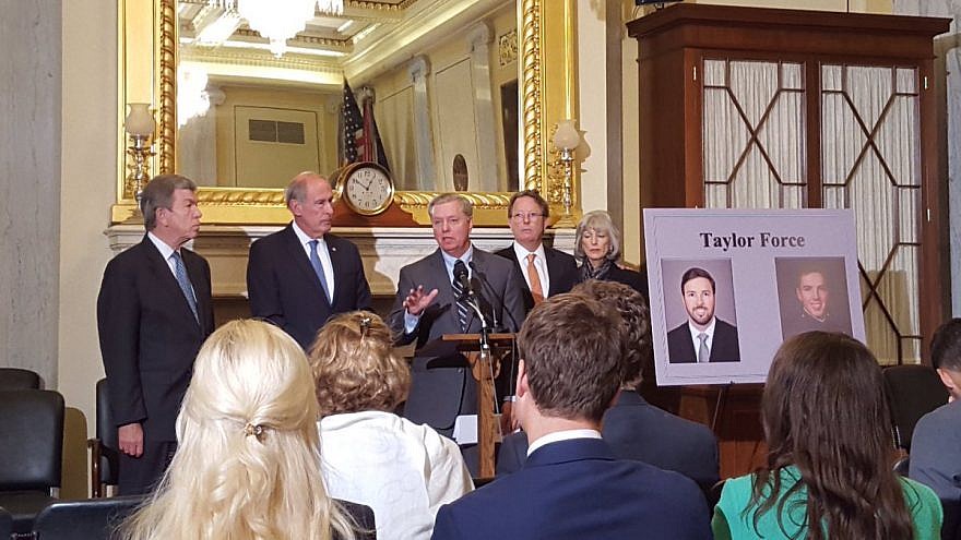 <p>The Taylor Force Act being introduced by Sen. Lindsey Graham (R-S.C.), Sen. Dan Coats (R-Ind.) and Sen. Roy Blunt (R-Mo.) in 2016. Taylor Force’s father, Stuart Force is pictured at the center-right. TWITTER/JNS</p>