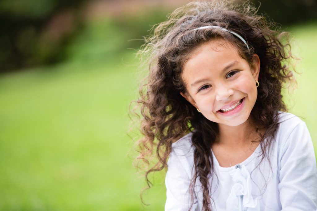 A young girl smiling in front of the camera. Each year in the UK, the number of allergy sufferers increases by five percent and half of all people affected are children. ESB PROFESSIONAL/SWNS TALKER