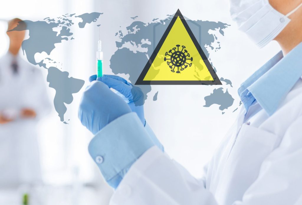 health, medicine and pandemic concept - doctor wearing protective medical mask with syringe over world map and coronavirus caution sign
