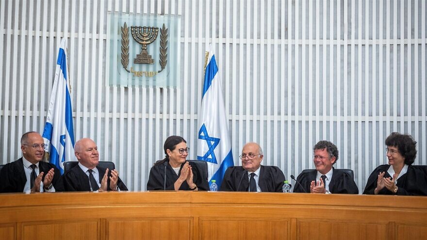 <p>Israeli Supreme Court President Esther Hayut (center) with other justices at court in Jerusalem, May 29, 2022. Israel’s High Court of Justice will hear petitions on Tuesday calling for it to strike down an amendment to a Basic Law. YONATAN SINDEL/JNS VIA FLASH90</p>