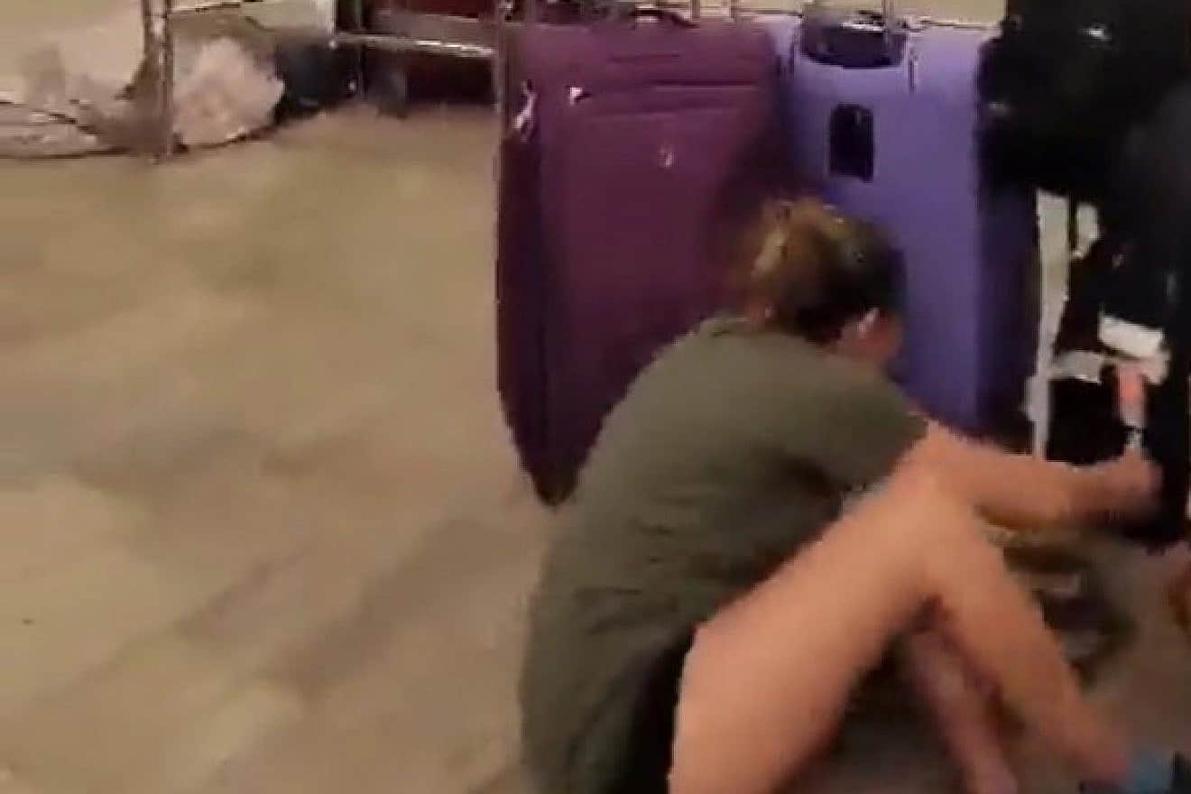 <p>A passenger at Ben Gurion Airport hides behind suitcases during a security incident, on Aug. 31, 2023. TWITTER/X.</p>