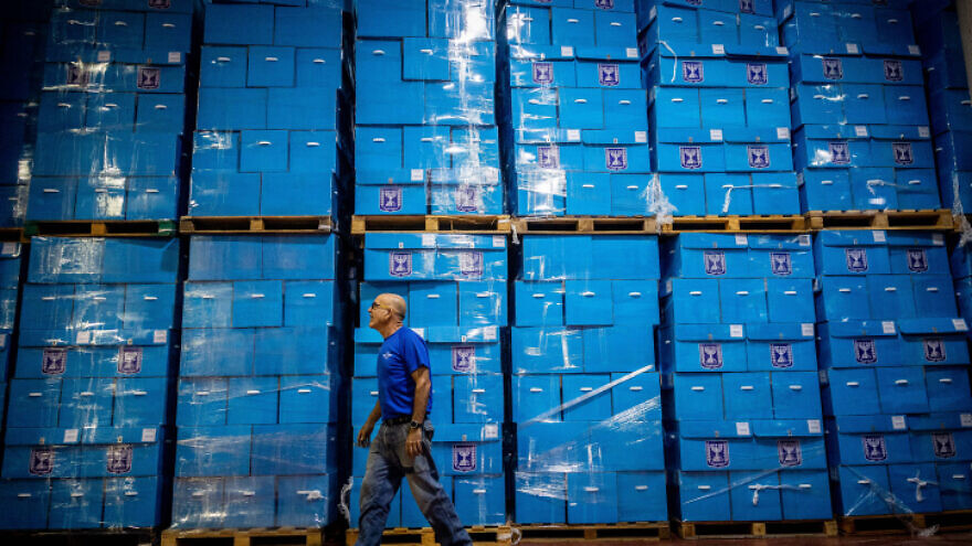 Workers prepare ballot boxes for the upcoming Israeli elections, at the central elections committee warehouse in Shoham, before they are shipped to polling stations, October 12, 2022. Photo by Yonatan Sindel/Flash90