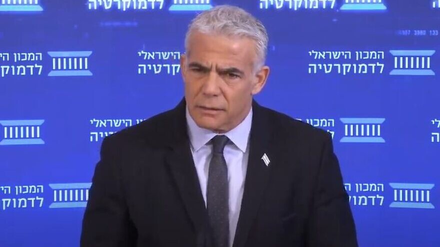 <p>Israeli Prime Minister Yair Lapid speaks at an Israel Democracy Institute conference in Jerusalem, Nov. 28, 2022. He reiterated on Wednesday Israel’s “wall-to-wall” commitment to preventing Iran from obtaining nuclear weapons, issuing a threat that Jerusalem would use military power if necessary. YOUTUBE/JNS</p>