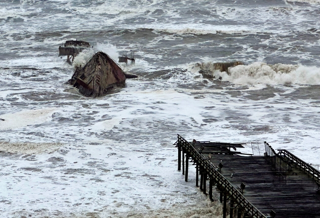 The pier leading to the Cement Ship in Aptos, California was severely damaged by storm surge on Thursday Jan. 5, 2023 One of the businesses facing the ocean, Bay Bar and Grill, had immense damage to the restaurant's interior, so much so that owner Patrick Lynn received a yellow tag from the city, meaning he needed special permission from the city's building department to go inside. SHMUEL THALER/ACCUWEATHER