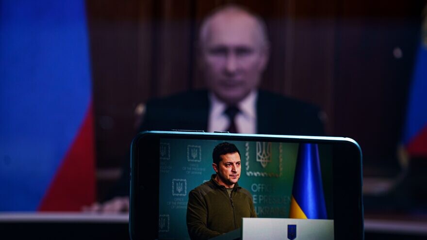 Kyiv, Ukraine - 2022, March 7: Volodymyr Zelensky the president of Ukraine on TV.  Russia president Vladimir Putin in the background