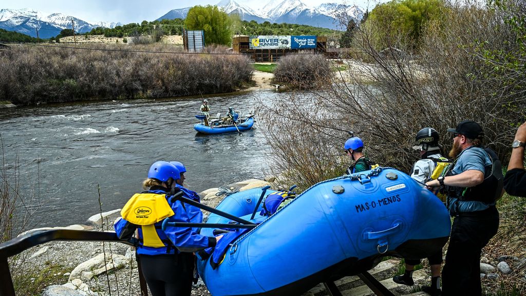 People carry their raft into the river for a white water rafting expedition in the Arkansas River in Buena Vista, Colorado, on May 17, 2023. A healthy Rocky Mountain snow pack looks set to offer a bumper season for thrill-seeking white water rafters on Colorado's rivers. Operators plying waterways fed by the US mountain range say a decent winter and a slow snow melt should offer months of fun for those intent on hurtling over bubbling rapids. CHANDAN KHANNA/ACCUWEATHER