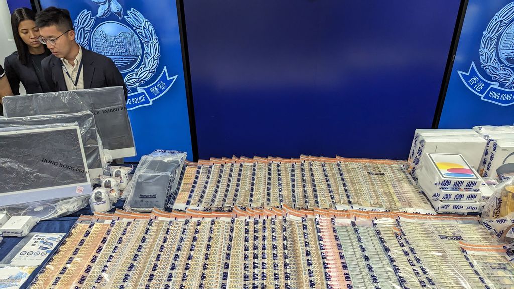 Hong Kong police display seized cash and other items at a press conference on September 19, 2023, after the arrests of eight people with ties to cryptocurrency platform JPEX. The arrests were made after authorities received more than 1,400 reports from potential victims who claimed to have lost around 128 million USD on troubled cryptocurrency exchange JPEX. HOLMES CHAN/AFP VIA GETTY IMAGES.