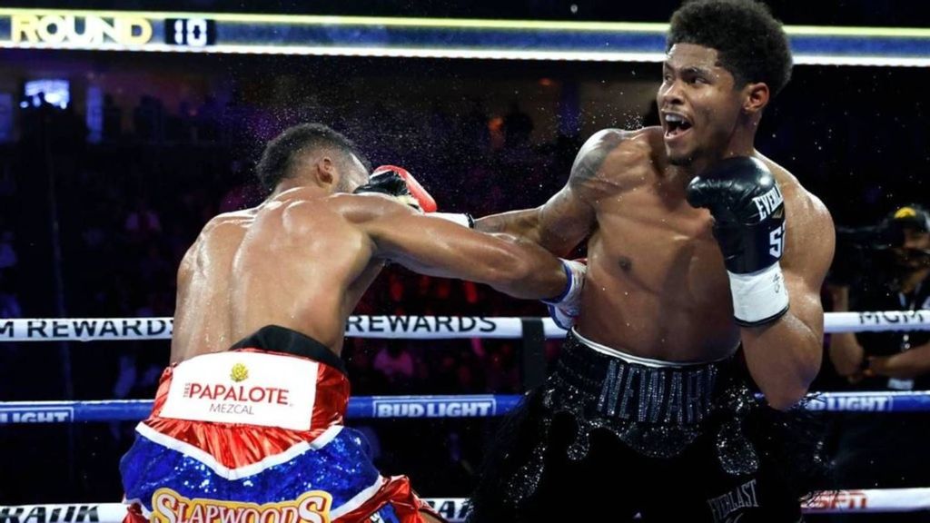 Edwin De Los Santos (L) ducks under a punch by Shakur Stevenson during a fight for a vacant WBC lightweight title in Las Vegas, Nevada. STEVE MARCUS/GETTY IMAGES. 