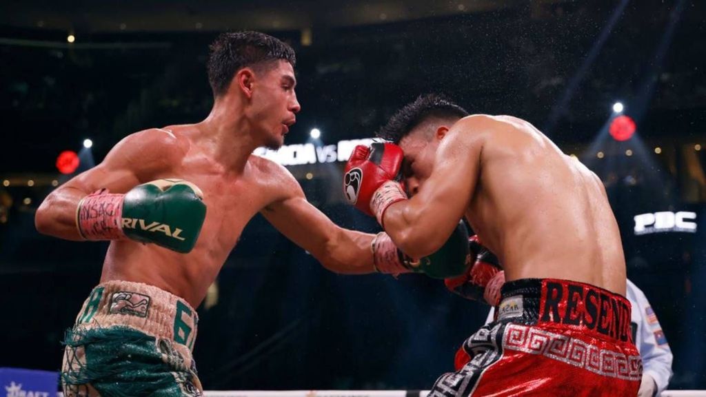 <p>Elijah Garcia (L) trades punches with Armando Resendiz of Mexico during their middleweight fight. Elijah Garcia media workout in Phoenix. SARAH STIER. </p>