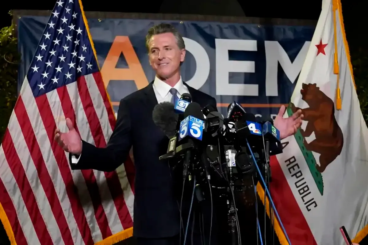 California Gov. Gavin Newsom addresses reporters Tuesday at the John L. Burton California Democratic Party headquarters in Sacramento after beating back the recall attempt that aimed to remove him from office. RICH PEDRONCELLI / AP 