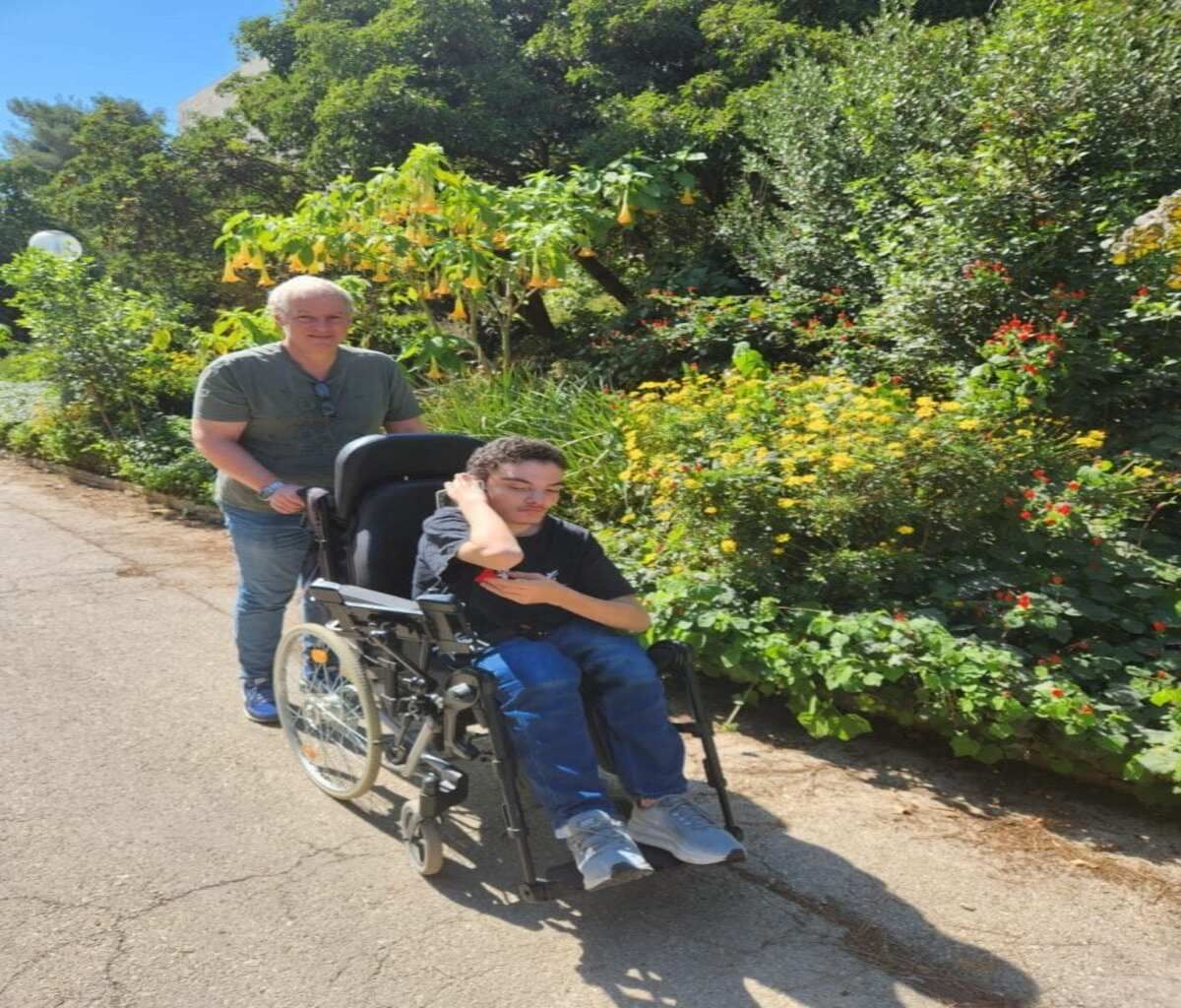 Yaron Segal wheeling his son, Lear, who has familial dysautonomia. COURTESY 