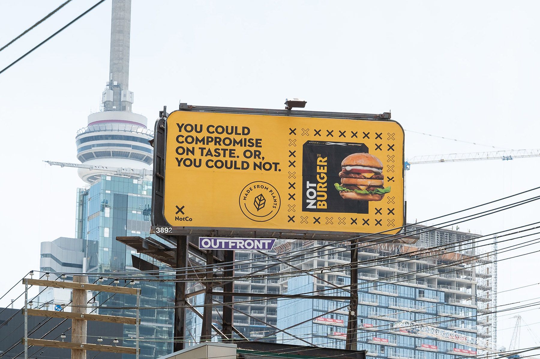 A NotBurger billboard in front of the CN Tower