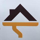 Logo of JRT Seamless Inc., featuring a stylized roof and gutter design in brown and gold, representing seamless gutter solutions.
