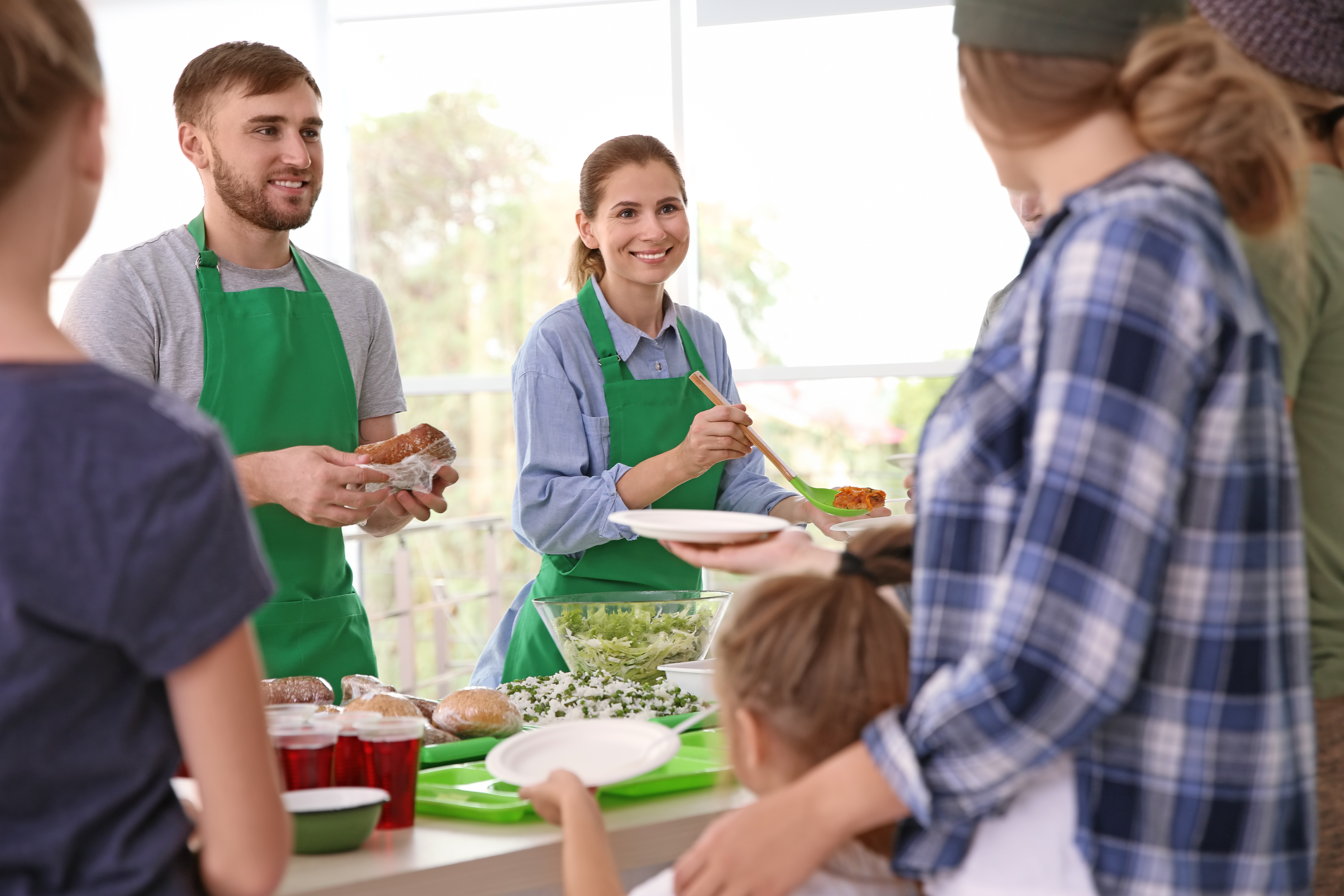 Man And Woman Serving Food