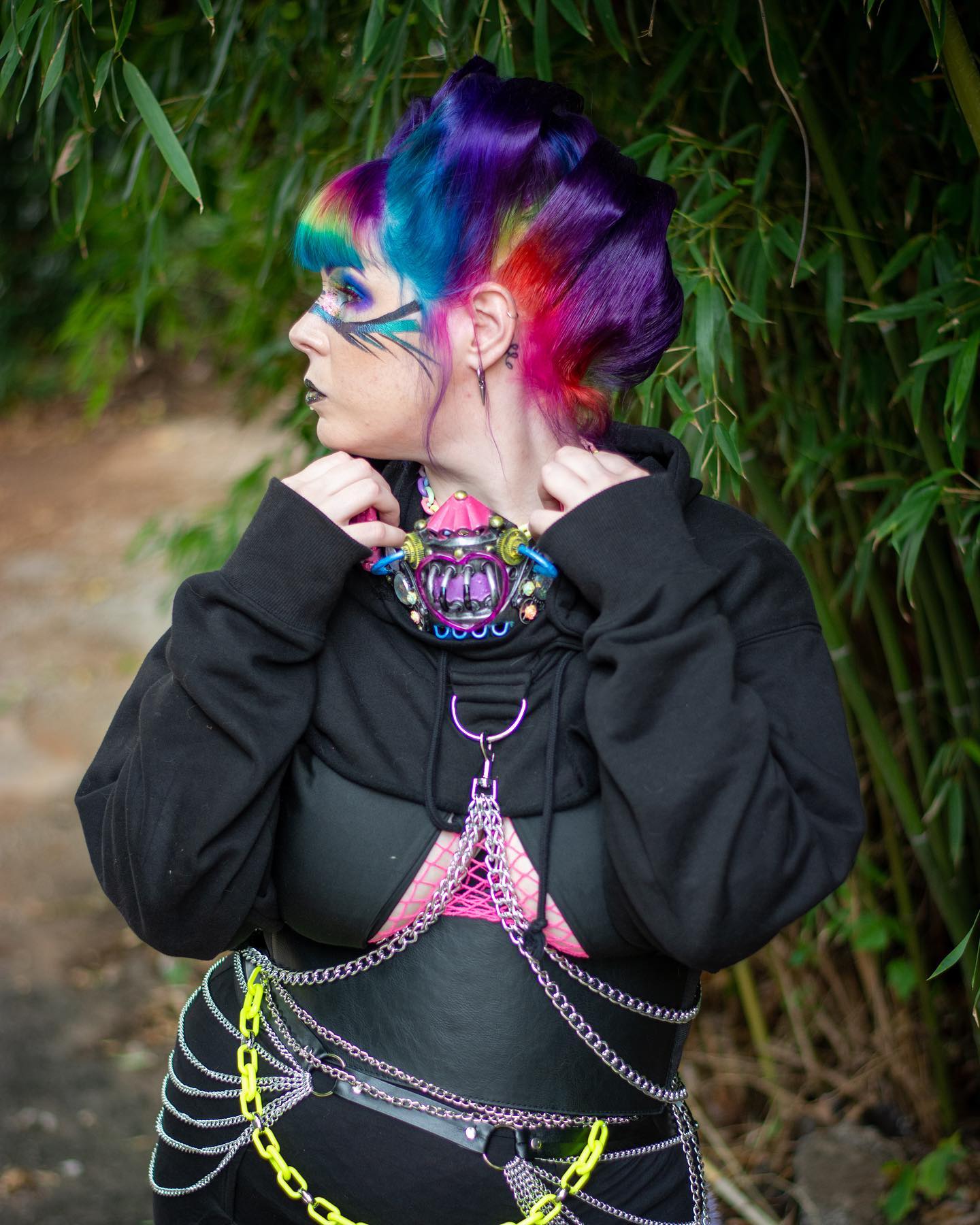Caucasian woman in her 20's with a rainbow hair in a retro updo 