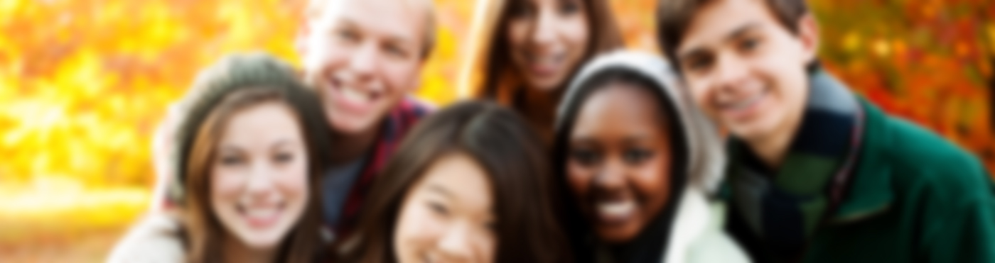 A diverse group of six smiling young adults
