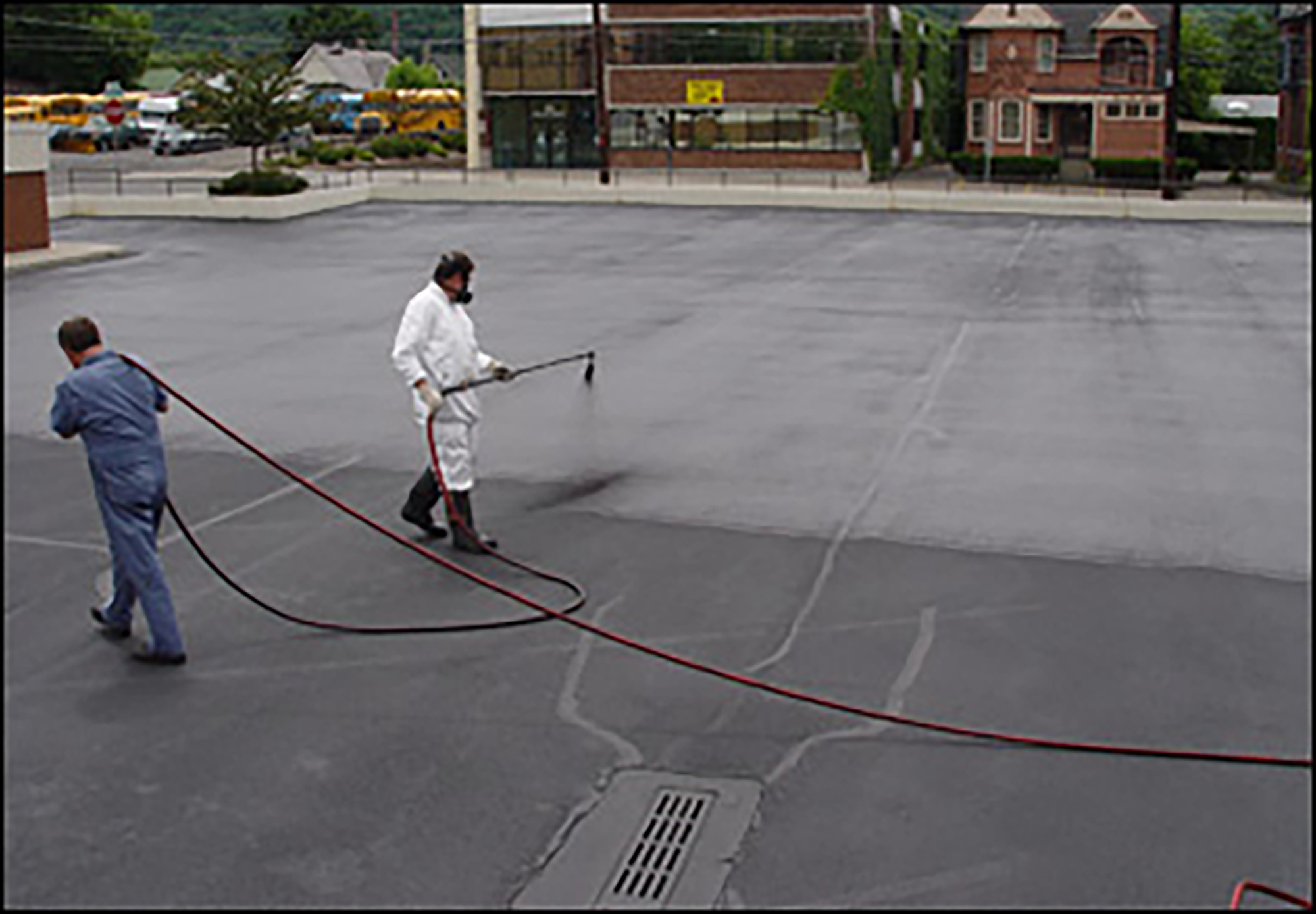 Two men sealcoating