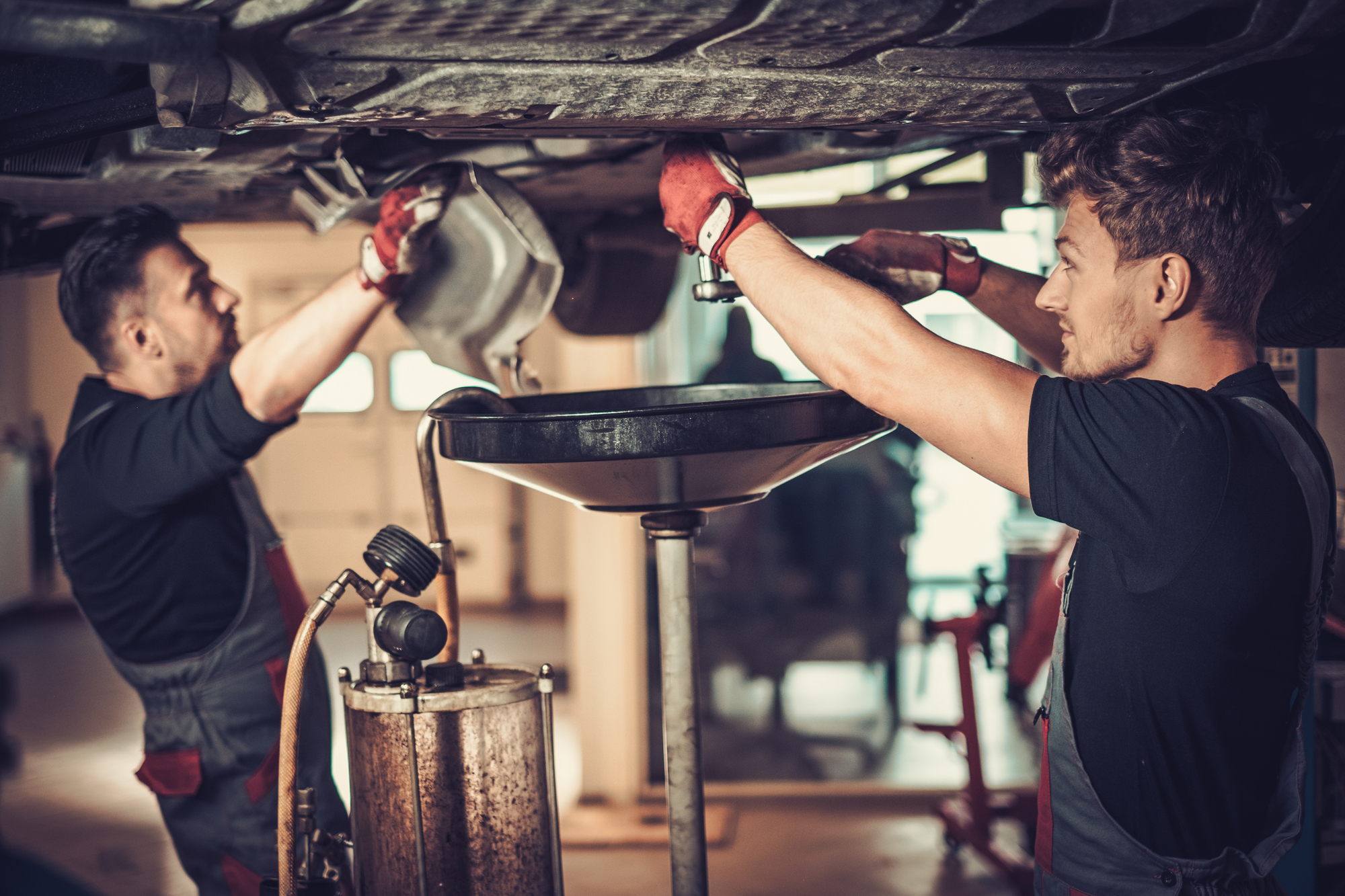 Men Working Under A Car