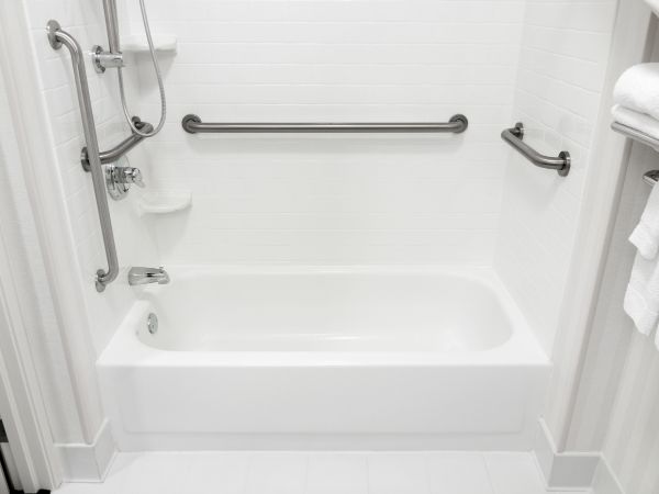 This image consist of 4 grab bars for support when using the bath tub. One vertical grab bar and three horizontal grab bars installed at a home in Bethesda, MD