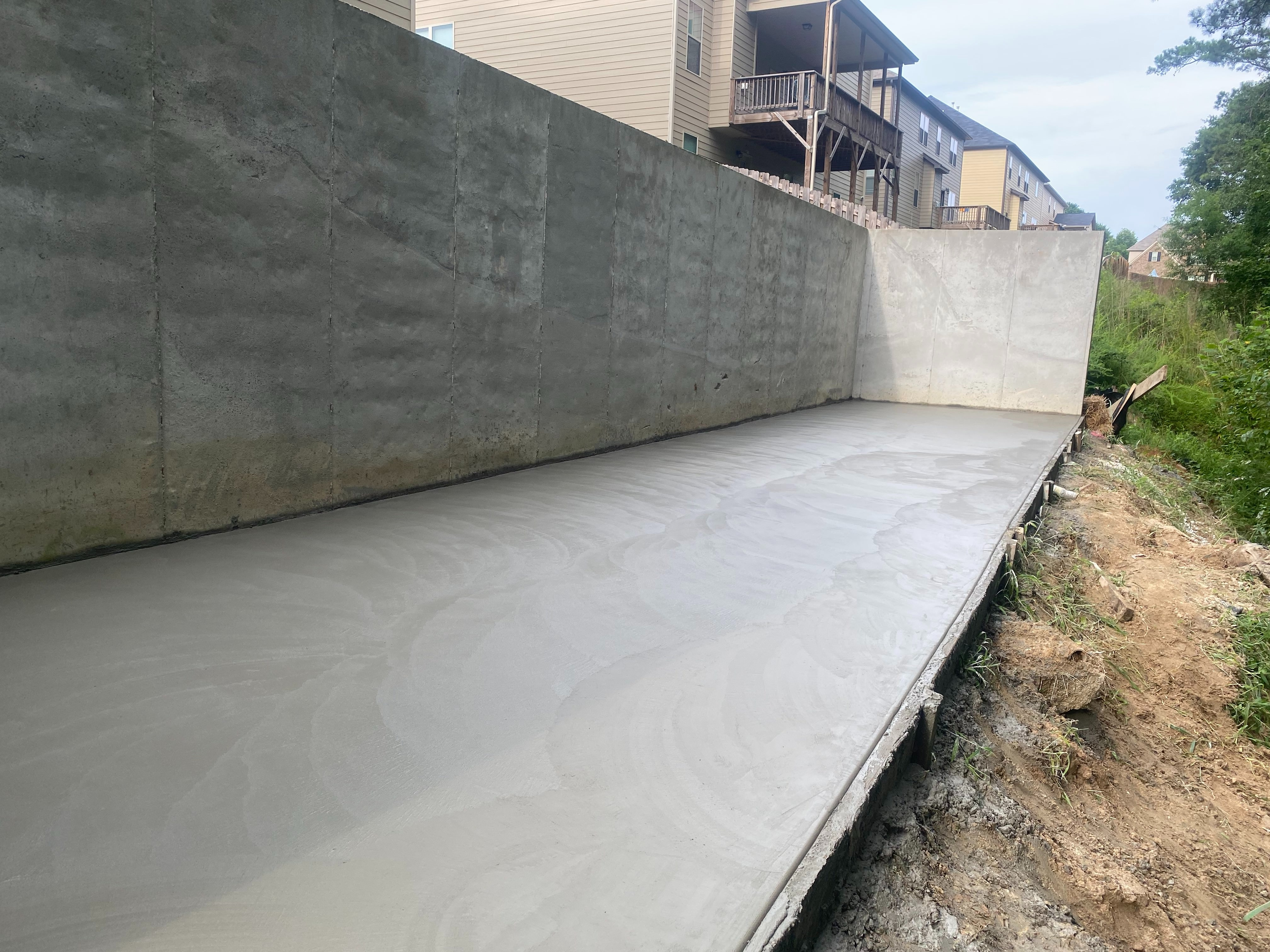 A high-quality smooth concrete finish expertly applied by GA Peach Concrete This finish offers durability, ease of maintenance, and a modern aesthetic.