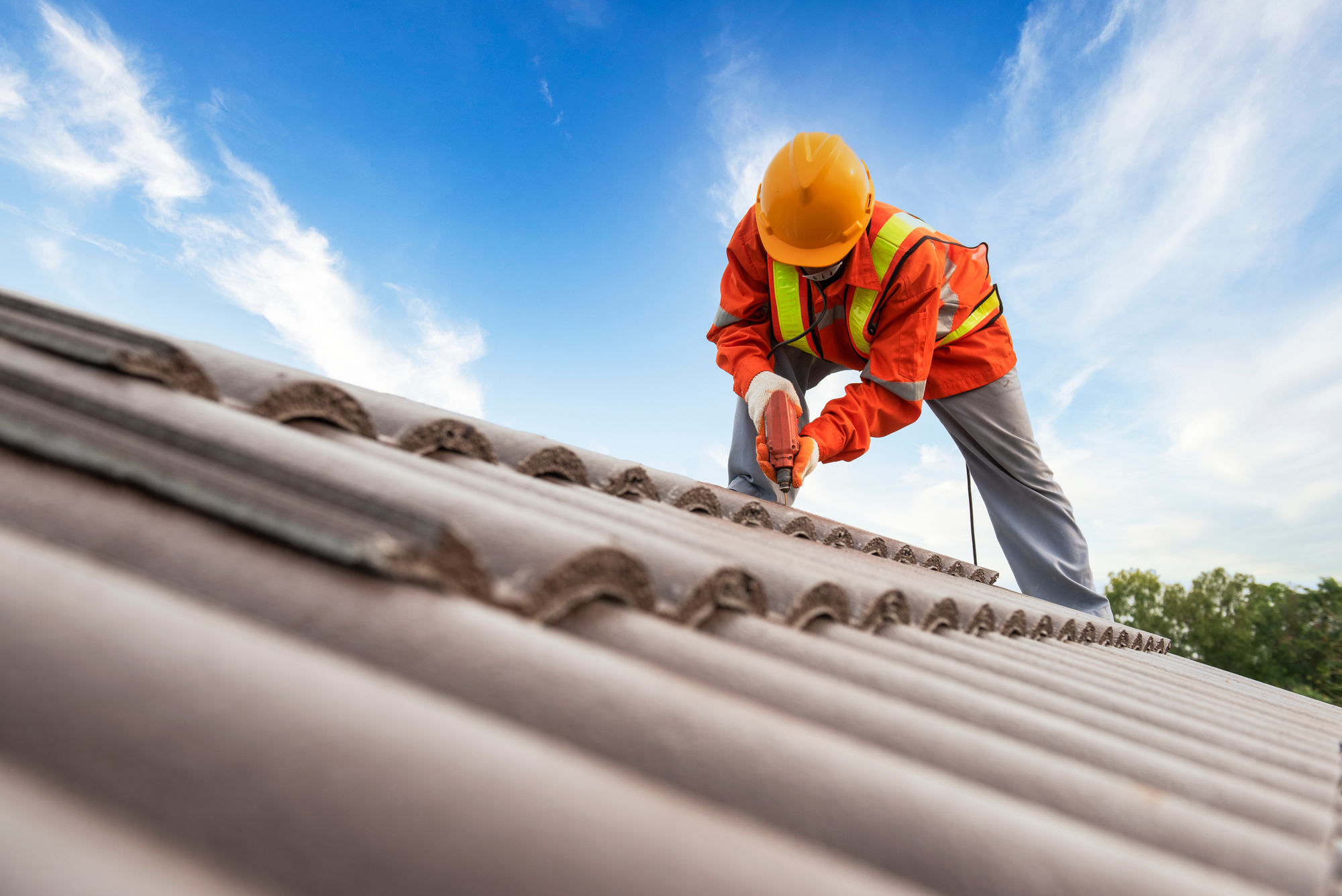 Worker Installing Roof Shingles