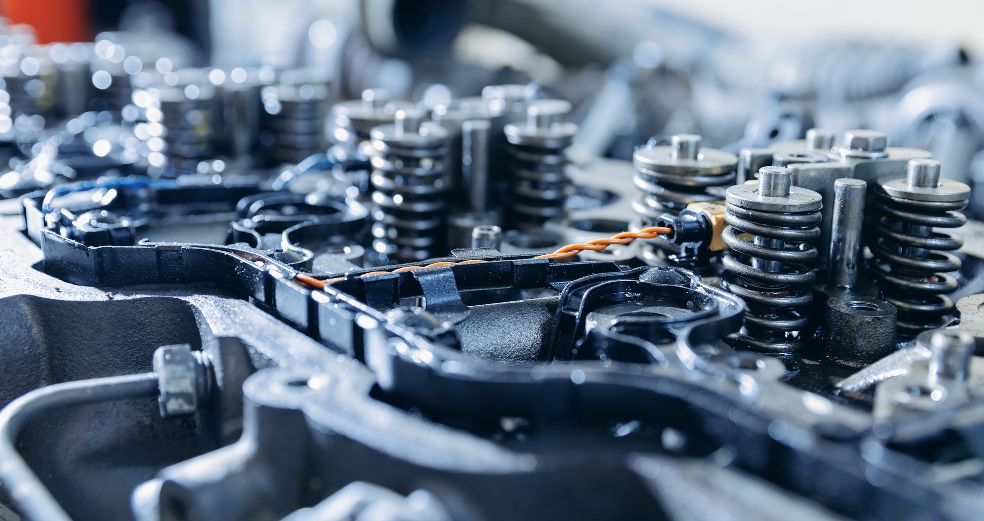 An engine with a wire connected to it, showcasing part of a mechanical assembly or system.