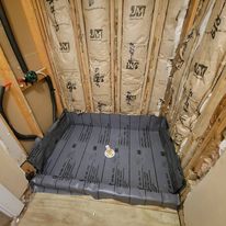 Rough Plumbing Of Shower Including Shower Valve And Vinyl Shower Pan And Drain Piping