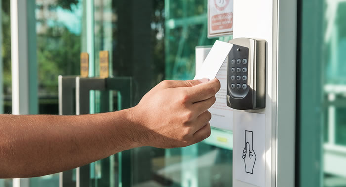 Man holding a key card for entery into a building