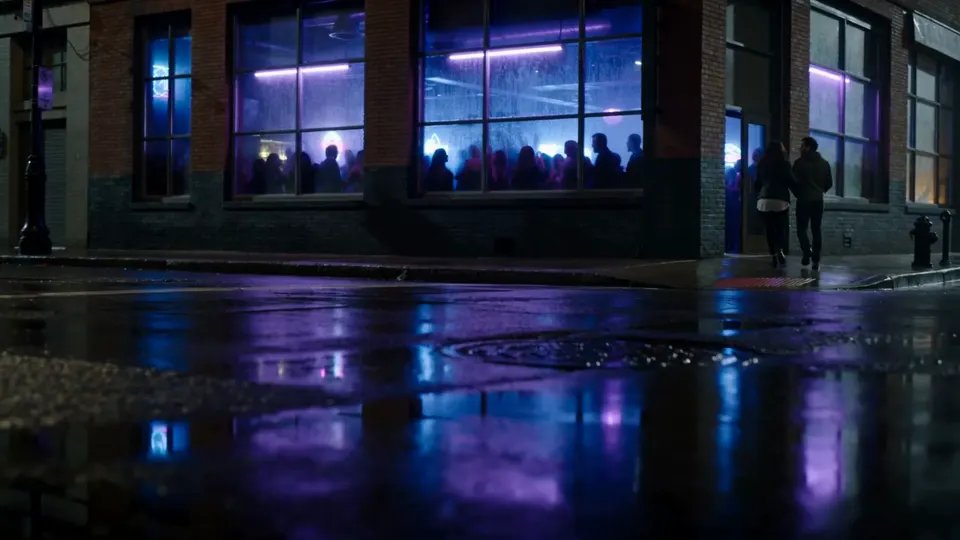 A different bar two blocks over: flat brick front, cool blue neon, windows packed with people
