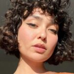 woman with brown, curly bob haircut