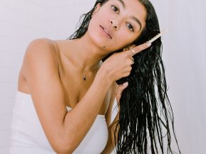 woman with long, black hair detangle hair