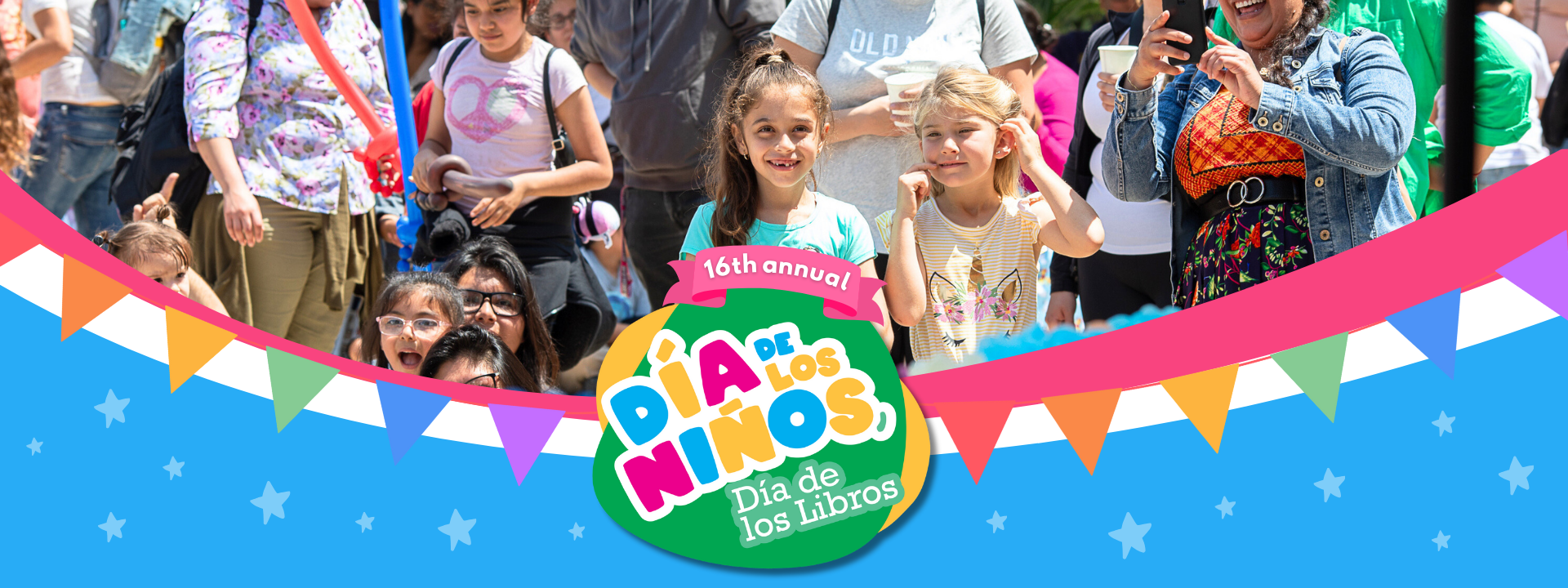 kids and parents standing in event with words Dia de Los Ninos, Dia de los libros in the center