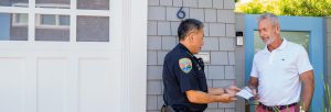 police officer talking to a resident outside their home