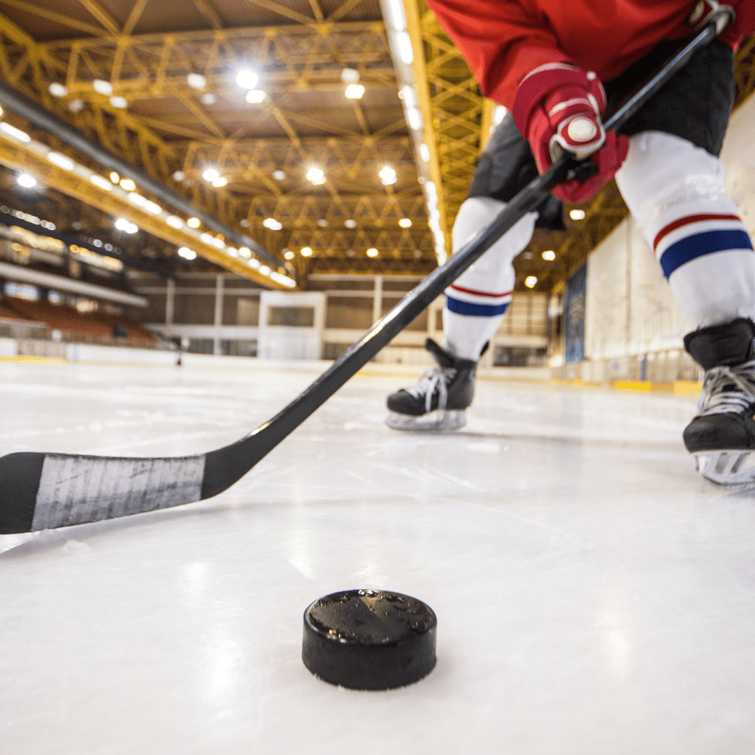 Hockey stick and hockey puck on ice