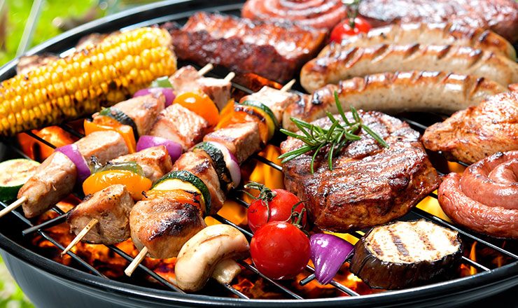 Meat and vegetables cooking on a barbeque