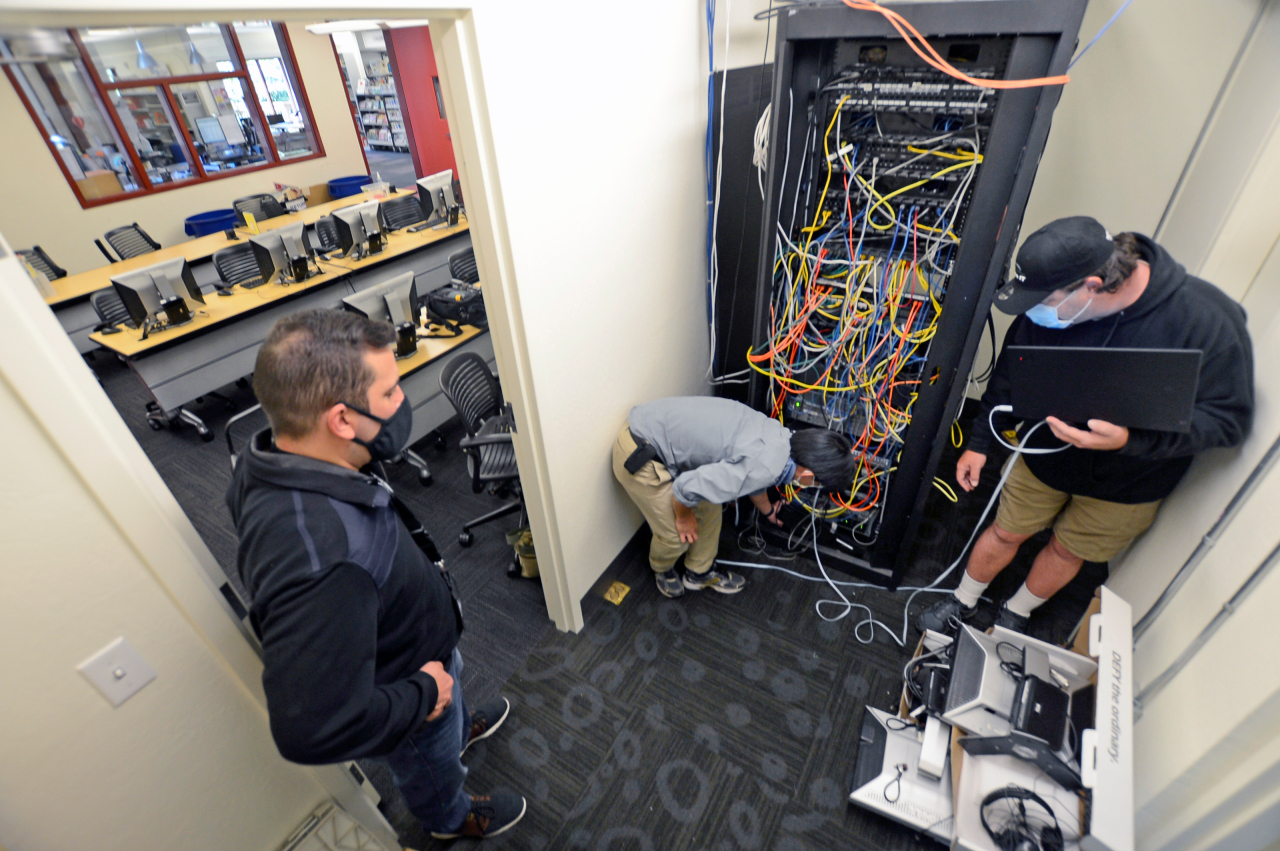 picture of people setting up network communications equipment