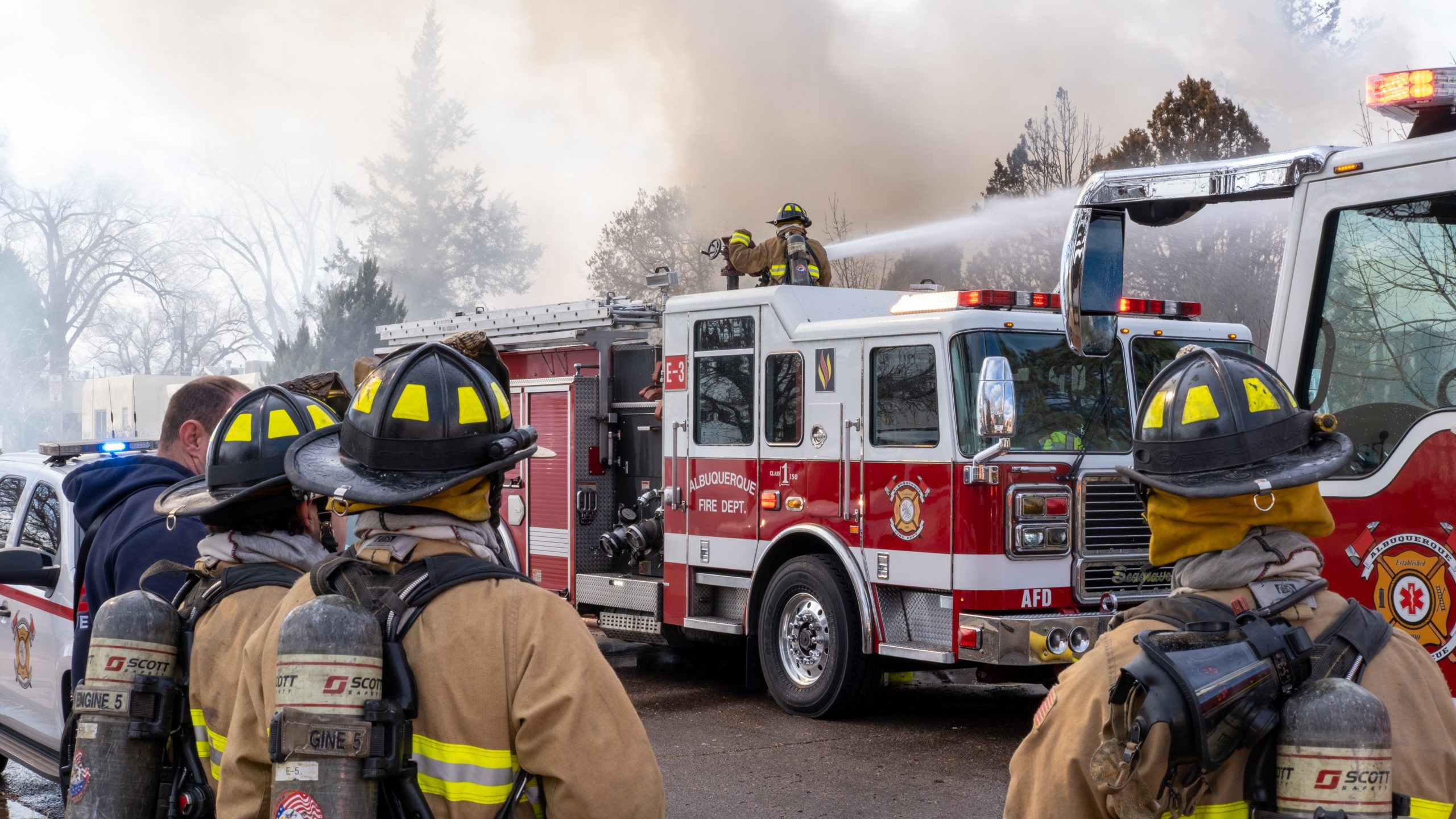 fire fighters outside during fire with fire trucks