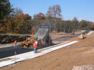 Construction crew paving a road