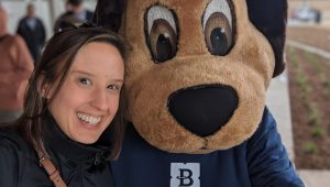 Maggie Allen and a dog mascot at a City of Bedford, TX Parks Board ribbon cutting.