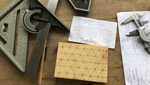 Measuring tools and notes on paper together on a desk or table top.