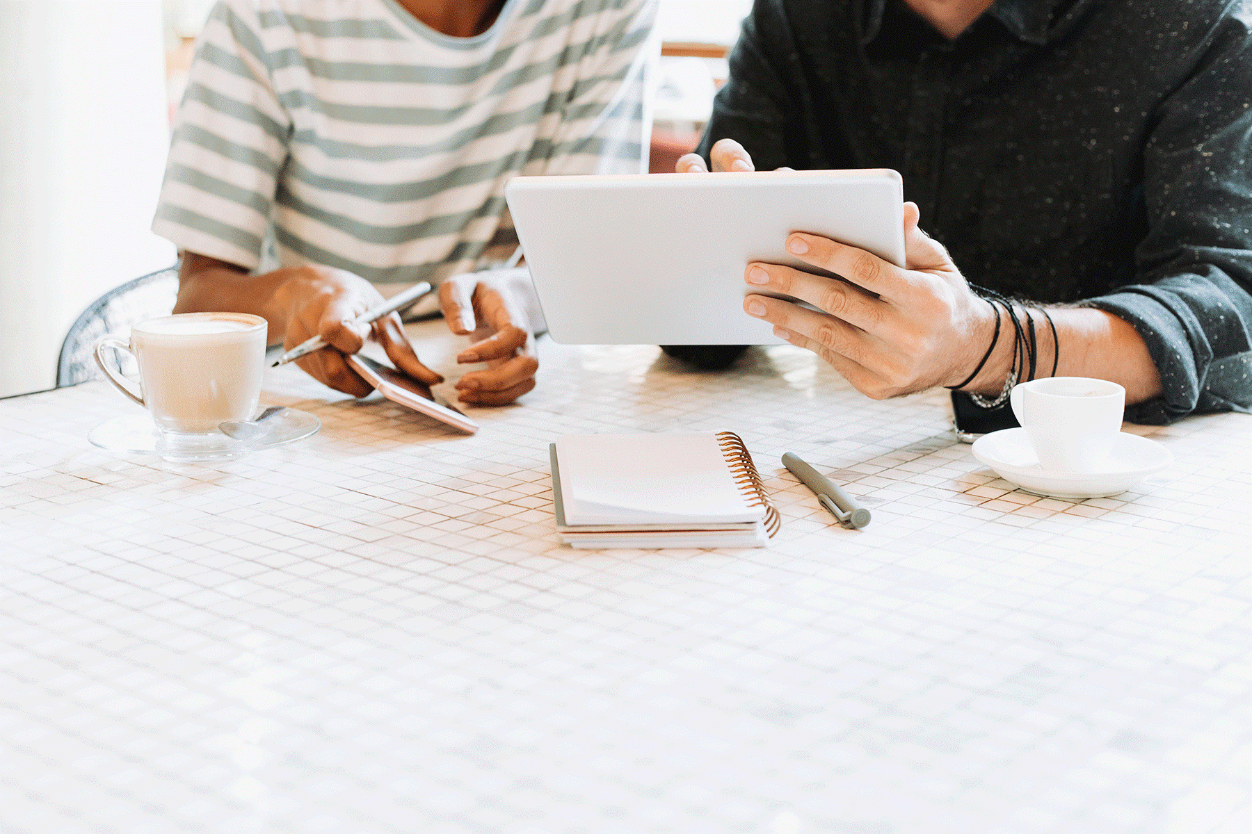 Two people looking at a tablet