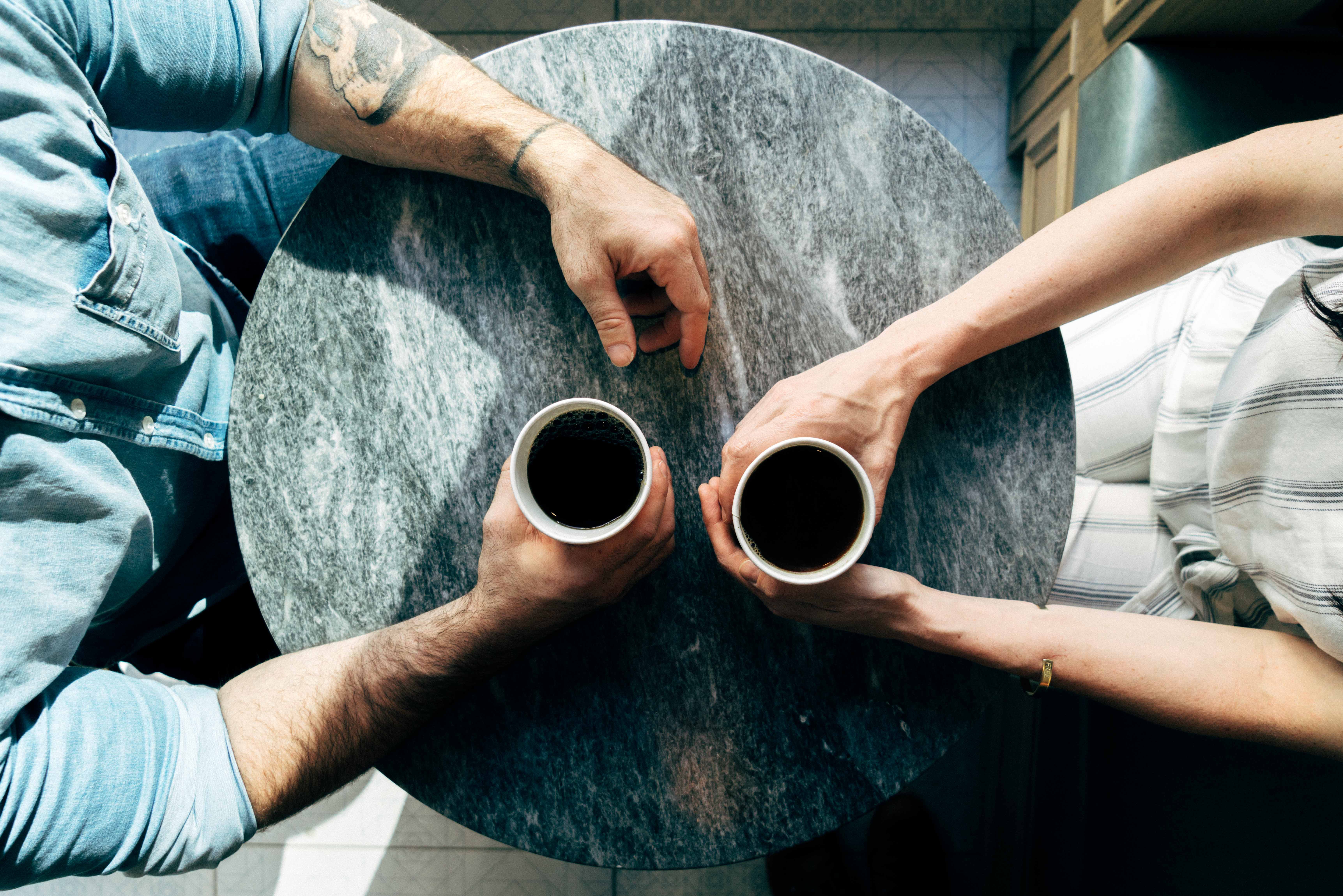 Two colleagues having coffee together