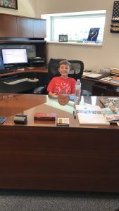 Boy at police chief desk