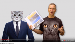 guy in cat t-shirt holding budget document next to CG cat