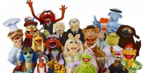 The Muppets smile as they celebrate being together. 