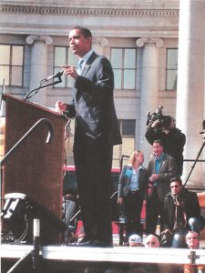 Photo Senator Barack Obama campaigns in Denver Civic Center Park in 2008 and Sarah Moss confers with a colleague on the media riser Photo by Ken Delgado