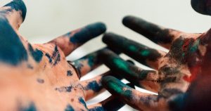 Hands covered in paint